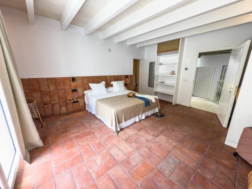 a bedroom with a bed and a tiled floor at Noualt Suites in Ferreries