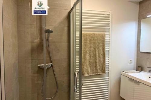 a shower stall in a bathroom with a sink at Sea View 1 BR Flat With Pool - Ideal For Couples & Families By SlowayStay Holiday Apartment & Short Term Rental Oostende in Ostend
