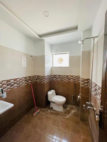 a bathroom with a toilet and a sink at The loft Single 1 in Islamabad