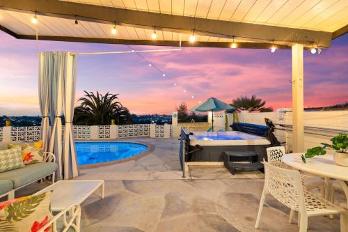 a patio with a pool and a table and chairs at Luxury Hilltop Stay Pool, Firepit and Views in La Mesa
