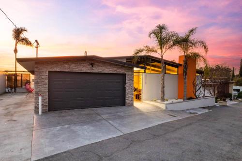 a house with a garage and palm trees at Luxury Hilltop Stay Pool, Firepit and Views in La Mesa