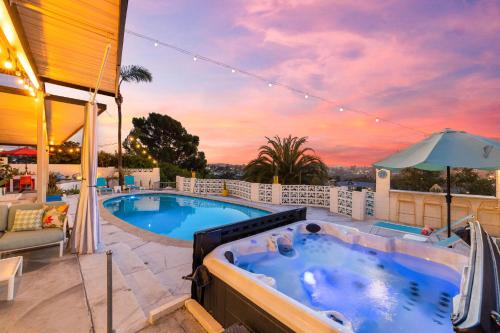 a hot tub on a patio with a sunset at Luxury Hilltop Stay Pool, Firepit and Views in La Mesa