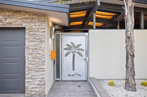 a door with a palm tree painted on it at Luxury Hilltop Stay Pool, Firepit and Views in La Mesa