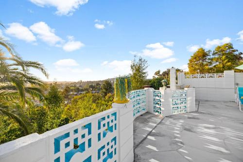 a white fence with blue and white tiles on a house at Luxury Hilltop Stay Pool, Firepit and Views in La Mesa
