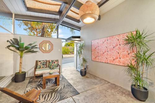 a living room with a bench and plants at Luxury Hilltop Stay Pool, Firepit and Views in La Mesa