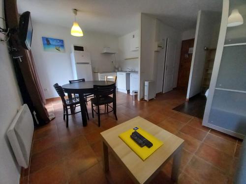 a living room with a table and chairs and a kitchen at Altissim Nevada II in Pas de la Casa