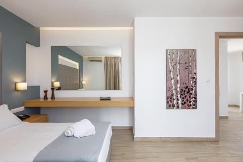 a hotel room with two beds and a mirror at Golden Bay Boutique Hotel & Bungalows in Kokkíni Khánion