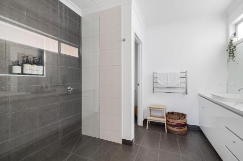 a bathroom with a shower and a sink at ALMA - sun filled stylish beach house in Torquay