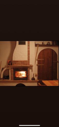 a living room with a fireplace in a room at Vinný sklípek s ubytováním in Bořetice