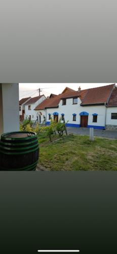 a stack of tires in front of a house at Vinný sklípek s ubytováním in Bořetice