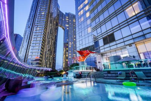 a pool in the middle of a city with tall buildings at The St. Regis Chengdu in Chengdu
