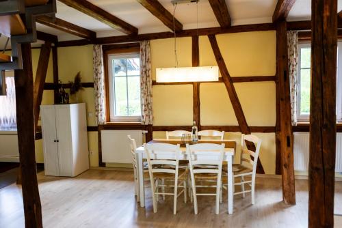 a dining room with a table and chairs at Landkulturhof Glücksbringer in Rudolstadt
