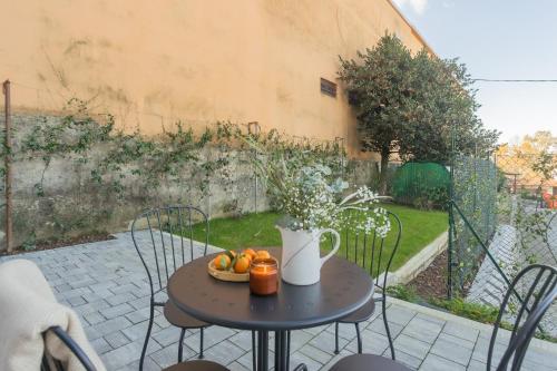 a table with a bowl of fruit on a patio at Isola Felice Grandate by Rent All Como in Como