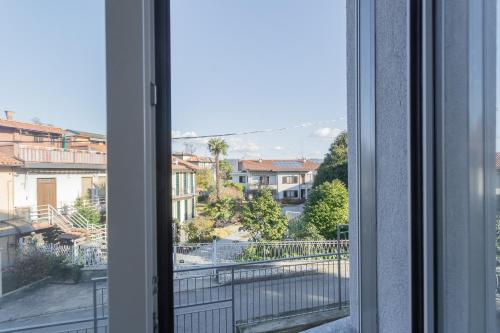 a window with a view of a city at Isola Felice Grandate by Rent All Como in Como