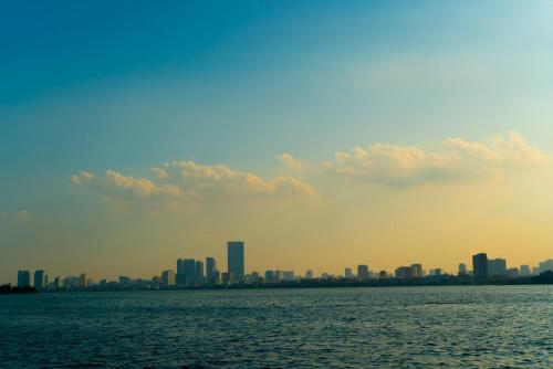 a view of a city from the water at Sushi House West Lake in Hanoi
