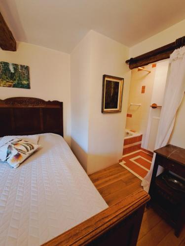 a bedroom with a bed and a bathroom at Dri les Courtils in La Roche-en-Ardenne