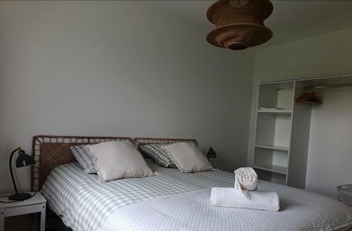a bedroom with a bed with a basket on it at L'Orge - Maison Design, 3 chambres, jardin et garage privatif in Vic-le-Comte
