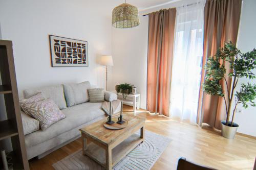 a living room with a couch and a coffee table at Eggenberg City Suites - Self Check-In in Graz