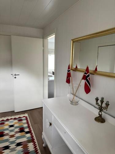 a room with a white dresser and a mirror at The Northern House in Gryllefjord