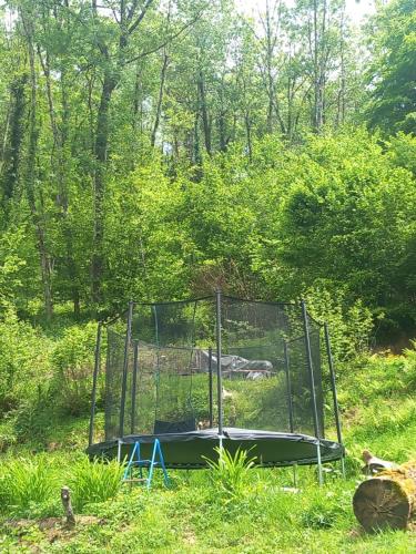 a batting cage in the middle of a field at Le chalet a la ferme in Massat