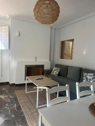 a living room with a couch and a table at Vivienda Turística Cronista Muro in Úbeda