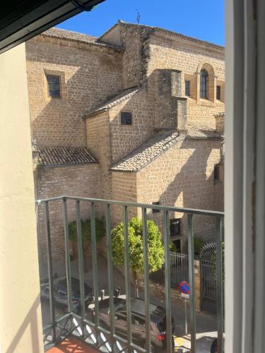 a view of a brick building from a window at Vivienda Turística Cronista Muro in Úbeda