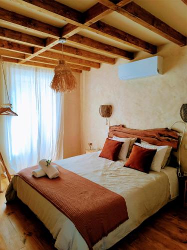 a bedroom with a large bed and a window at AMEIO - Country House in Rio Maior