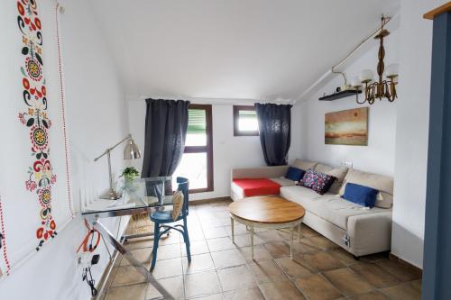 a living room with a couch and a table at La Casa del Risco Zahara in Zahara de la Sierra