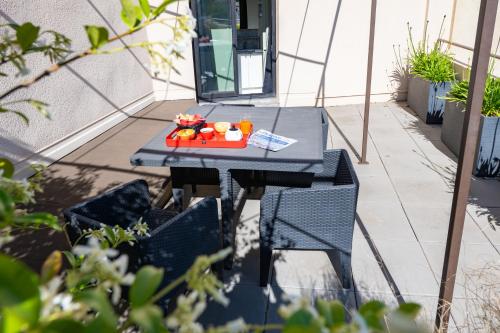 a tray of food sitting on a table on a patio at ibis Avignon Centre Pont De L'Europe in Avignon