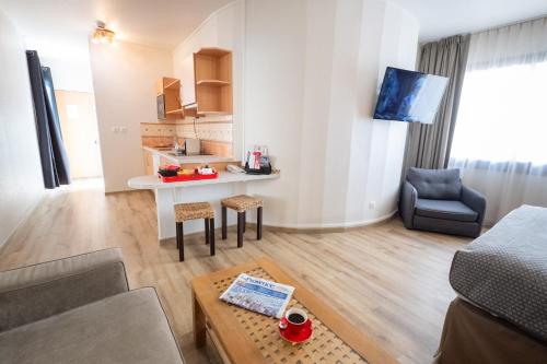 a living room with a couch and a table at ibis Avignon Centre Pont De L'Europe in Avignon