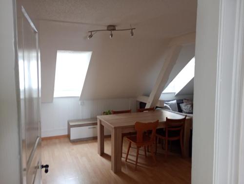 a dining room with a table and some chairs at Gemütliches Dach-Zimmer in St. Gallen