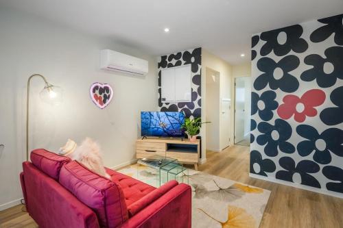 a living room with a red couch and a mirror at Birch Street Solo Haven in Lower Hutt
