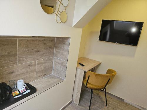 a small room with a television and a chair at Hotel Taurus in Ostrava