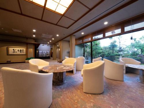 a lobby with white chairs and a table at Ryotei Jyusouya in Sango