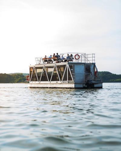 a group of people on a boat on the water at Dom na Wyłączność z Wanną z Hydromasażem, Sauną i Basenem in Mucharz