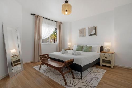 a bedroom with a bed and a chair and a window at Nice Casa los Naranjos Marbella by Casa del Sol HR in Marbella