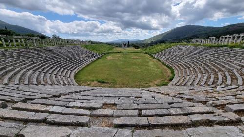 an amphitheater with a grass field in the middle at Comfort Holidays in Messini