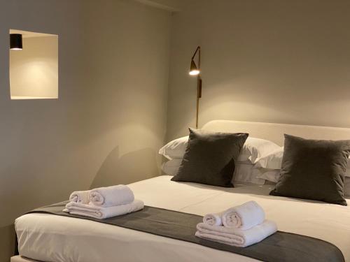 a bedroom with two white towels on a bed at Suite74 in Carovigno