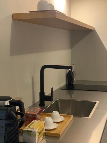 a kitchen counter with a sink and a faucet at Suite74 in Carovigno