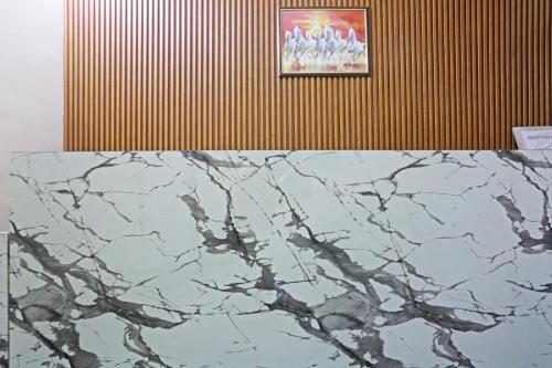 a marble counter top with a picture on a wall at Swastik residency Laxmi Nagar by Twamev in New Delhi