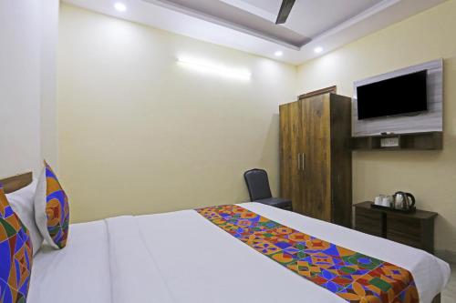 a hotel room with a bed and a tv at Swastik residency Laxmi Nagar by Twamev in New Delhi
