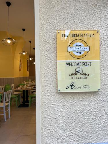 a sign on the wall of a restaurant at Hotel Cineholiday in Naples