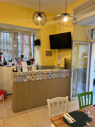 a restaurant with a bar with a table and chairs at Hotel Cineholiday in Naples