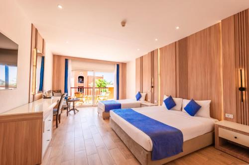 a hotel room with two beds and a balcony at Sentido Caribbean World Soma Bay in Hurghada