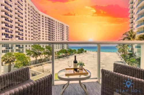 a view of a balcony with a table with a bottle of wine at Tides beautiful ocean view condo-promotions in Hollywood
