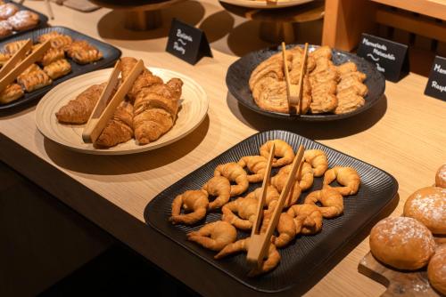 a table with plates of pastries and other pastries on plates at HM Jaime III in Palma de Mallorca
