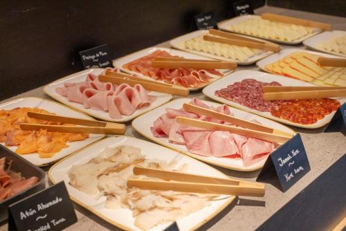 a table full of different types of meats and cheese at HM Jaime III in Palma de Mallorca