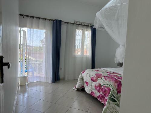 a bedroom with a bed and a window at 3Bedroom Hilltop Home In Muyenga in Kampala
