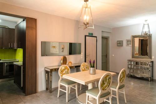 a kitchen and dining room with a table and chairs at Silot apartment 1 in Nea Fokea
