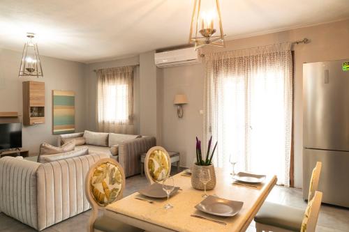 a living room with a table and a couch at Silot apartment 1 in Nea Fokea